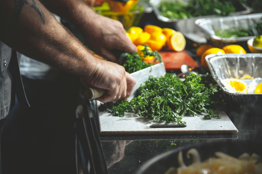 Food preparation equipment on a commercial kitchen prep bench