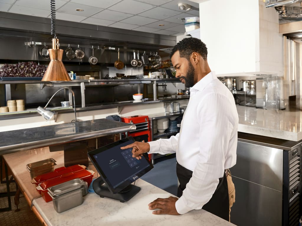 Chefs working across a commercial kitchen preparation workflow